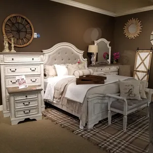 Antiqued white bedroom set. Shown with upholstered queen headboard.