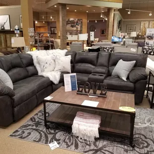 Dark reclining sectional paired with accent pillows and throw blanket