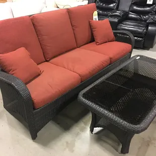 Wicker Sofa and wicker coffee table w/ glass top *Availability may vary.