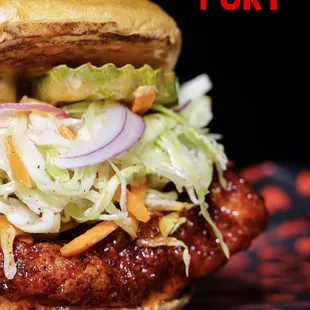 a chicken sandwich with coleslaw and slaw