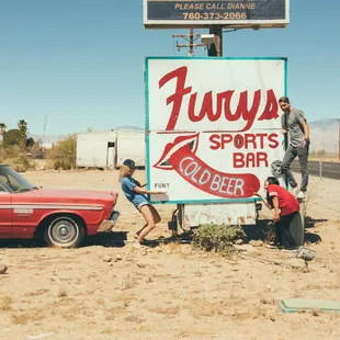 two men working on a sign