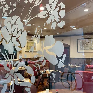 a dining room with a glass wall