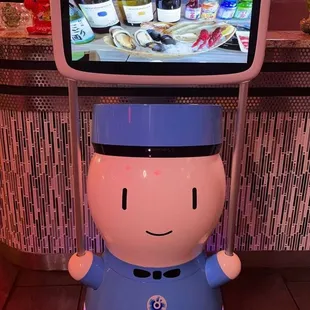 a robot holding a tv