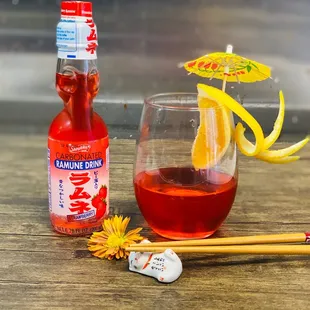 a glass of fushimi with a straw and umbrella