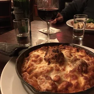 a dish of pasta and meatballs