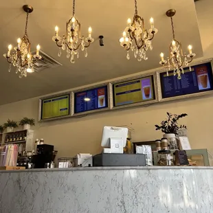 a marble counter with chandeliers