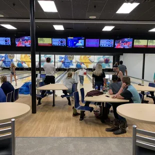 people playing bowling in a bowling alley