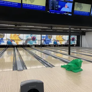 a bowling alley with a green toy