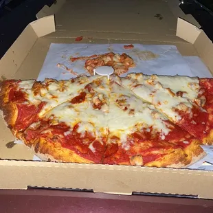 Meat lovers pizza with meat underneath a pound of cheese