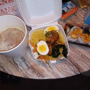 a bowl of noodles and a cup of coffee
