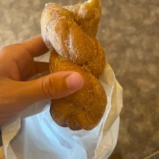 a hand holding a doughnut