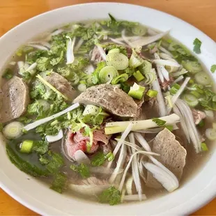 a bowl of soup with meat and vegetables
