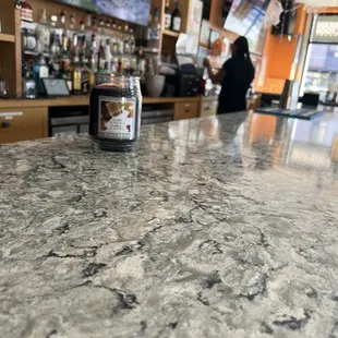 a bar counter with a candle on it
