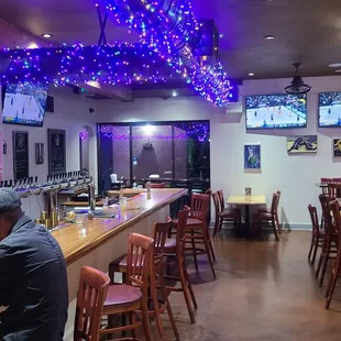 a man sitting at a bar in a restaurant