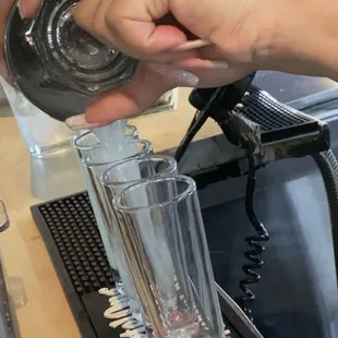 a person pouring a drink
