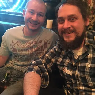 two men sitting next to each other