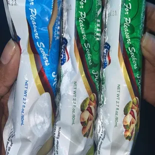 a person holding two bags of chips