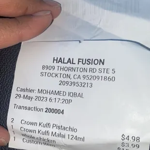 a hand holding a piece of paper