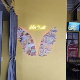 a neon sign above a table