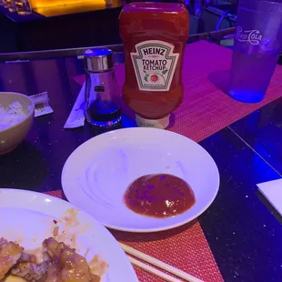 a plate of food and a bottle of ketchup