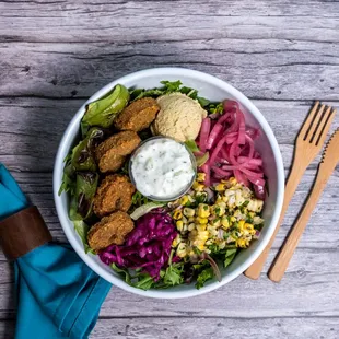 a bowl of salad and a fork