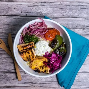 a bowl of food on a wooden table