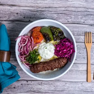 a bowl of food on a wooden table