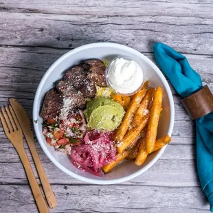 a bowl of food on a wooden table