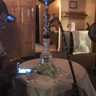 a man sitting at a table with a hook