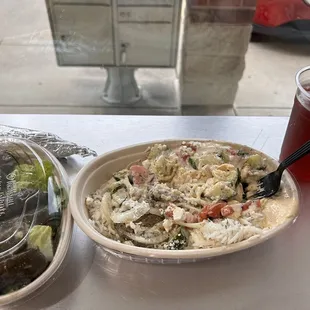 Rice and hummus bowl with dolmas on the side. Berry and apple cider vinegar beverage.