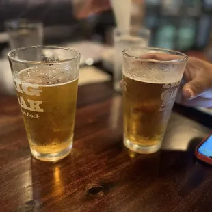 two glasses of beer on a table