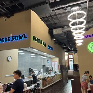 customers at the counter of a poke bowl restaurant