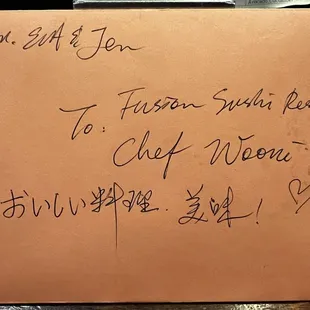 A letter from a customer at Fusion Sushi for Chef Woomi and server Landon, thanking them for the amazing service and cuisine.