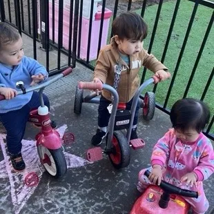 The infant playing outside. They give outdoor time to promote good health and fresh air.