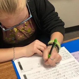 Learning the lost art of cursive writing.