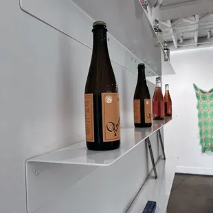 three bottles of wine on a shelf