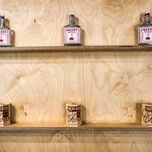 three bottles of liquor on a shelf