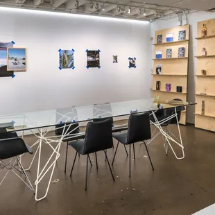 a glass table and chairs in a room