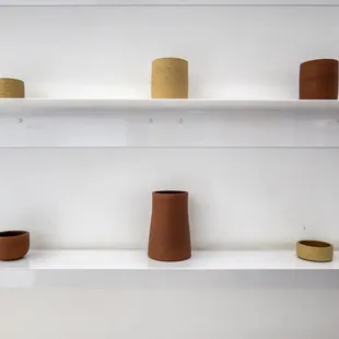 a row of vases on a shelf