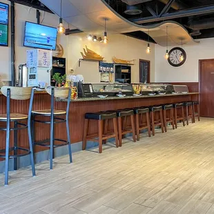 a restaurant with a bar and televisions