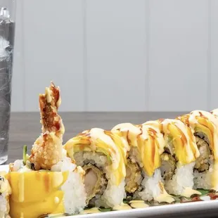 a plate of sushi and a glass of water