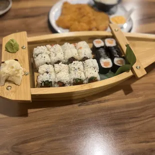 a wooden boat with sushi on it