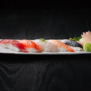 a plate of sushi on a wooden table