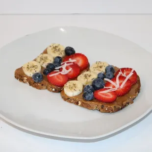 two pieces of toast with fruit on it