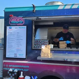 a man ordering food from a food truck