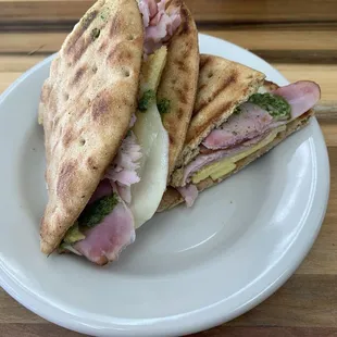 Breakfast sandwich with ham on pita with a drizzle of pesto