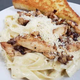 a plate of pasta with chicken and cheese