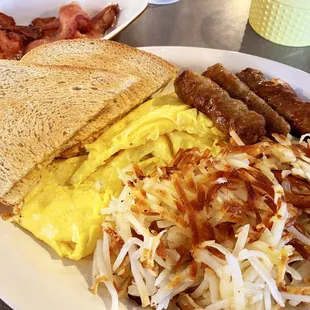 2 eggs scrambled, hash browns- crispy, bacon, sausage and rye toast