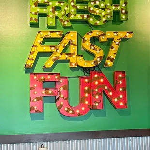 a neon sign that says fresh fast fun