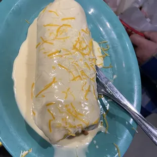 Burrito smothered in queso